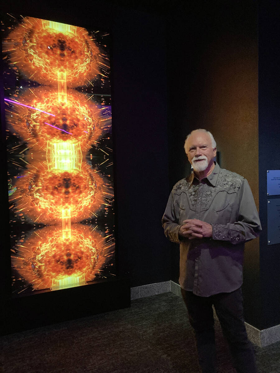 James Stanford stands next to his 10-foot-tall “Spectre Fission” art piece installed in “ ...