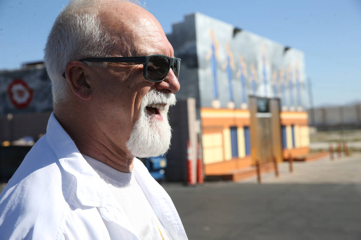 James Stanford talks to a reporter in front of his mural, ÒA Phalanx of Angels Ascending&q ...