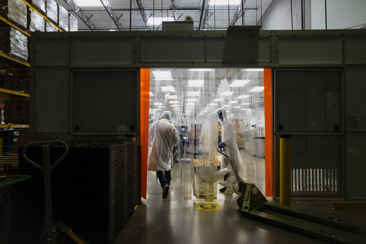 Employees prepare to move boxes of vitamins into the storage area as seen during a tour of the ...
