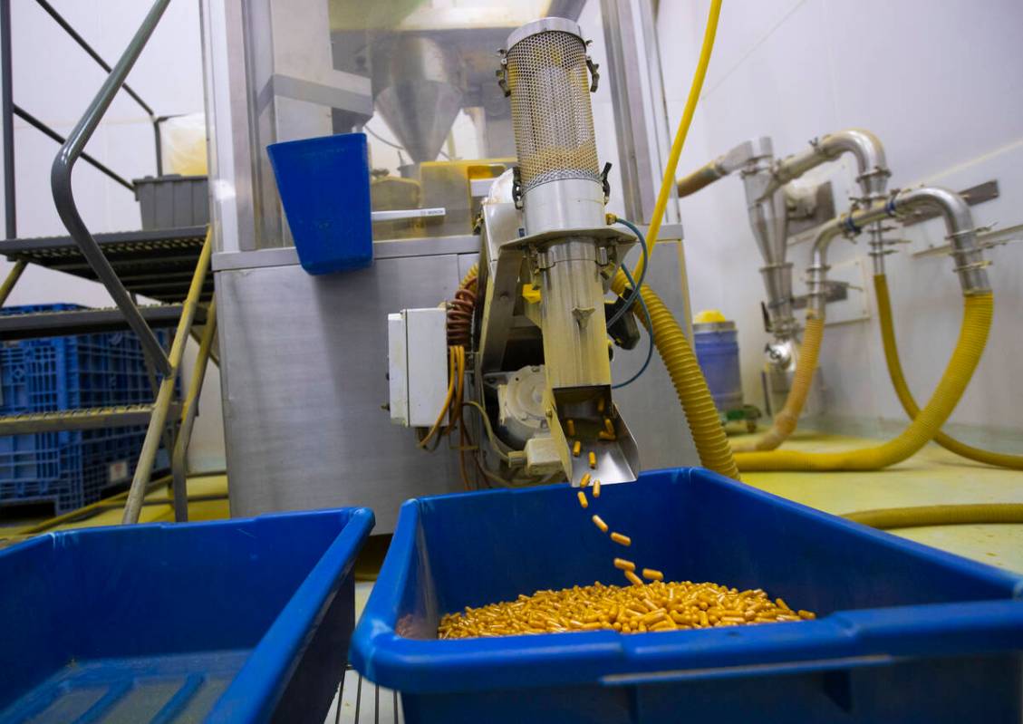 A press machine releases turmeric capsules during a tour of the Nature’s Lab facility on ...