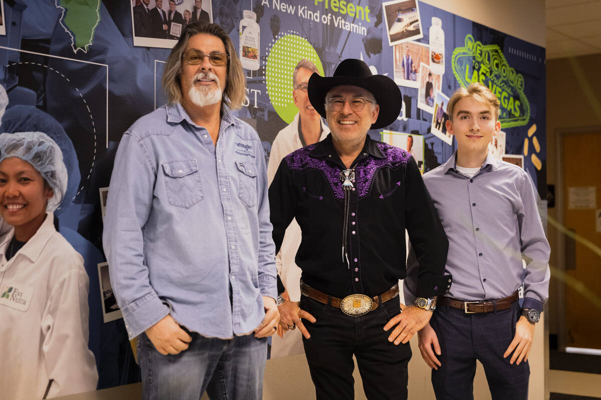 Wayne Gorsek, founder, chairman and CEO of DrVita, center, poses for a photo with James Smith, ...