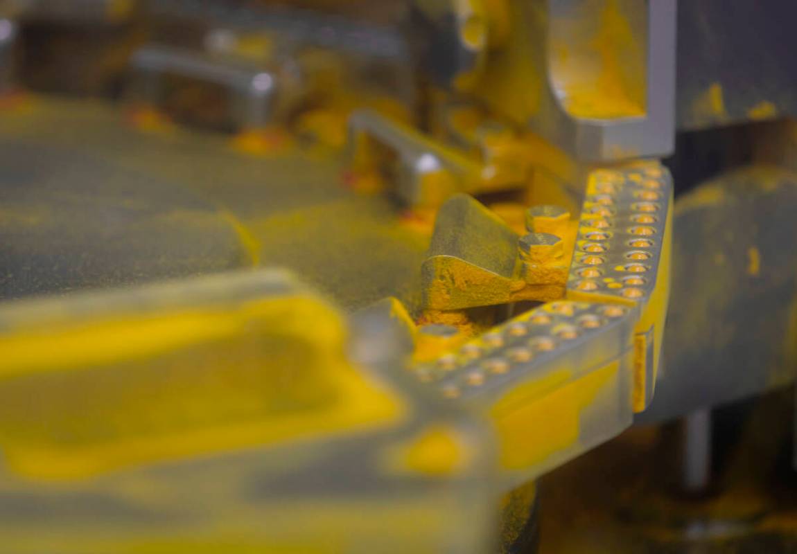 A press machine prepares turmeric capsules during a tour of the DrVita facility on Thursday, Fe ...