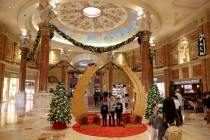 Tien Vu of Huntington Beach, Calif. takes a holiday photo of her sons, from left, Jacob, 6, Eth ...