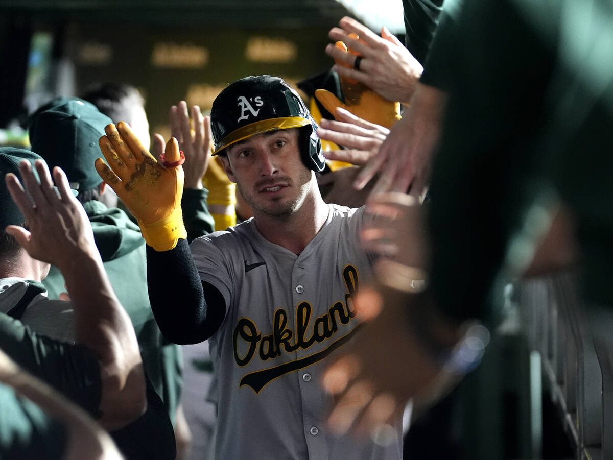 Oakland Athletics' Brent Rooker is greeted in the dugout after his two-run home run off Chicago ...