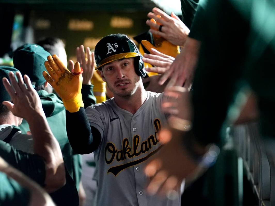 Oakland Athletics' Brent Rooker is greeted in the dugout after his two-run home run off Chicago ...