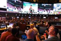Guests watch on the big screens the first day of the NCAA basketball tournament at Westgate spo ...