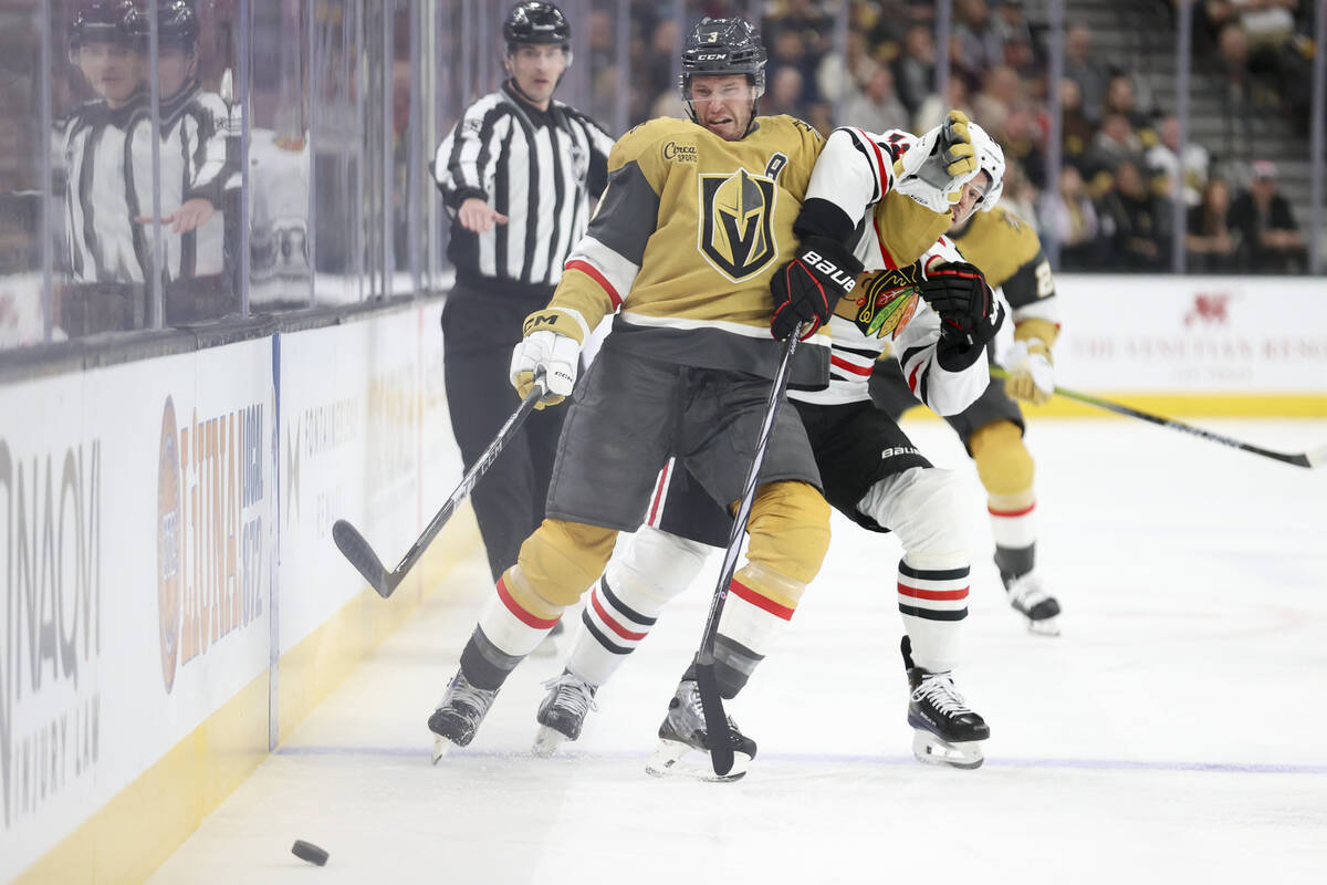 Vegas Golden Knights defenseman Brayden McNabb (3) gets tangled up with Chicago Blackhawks cent ...