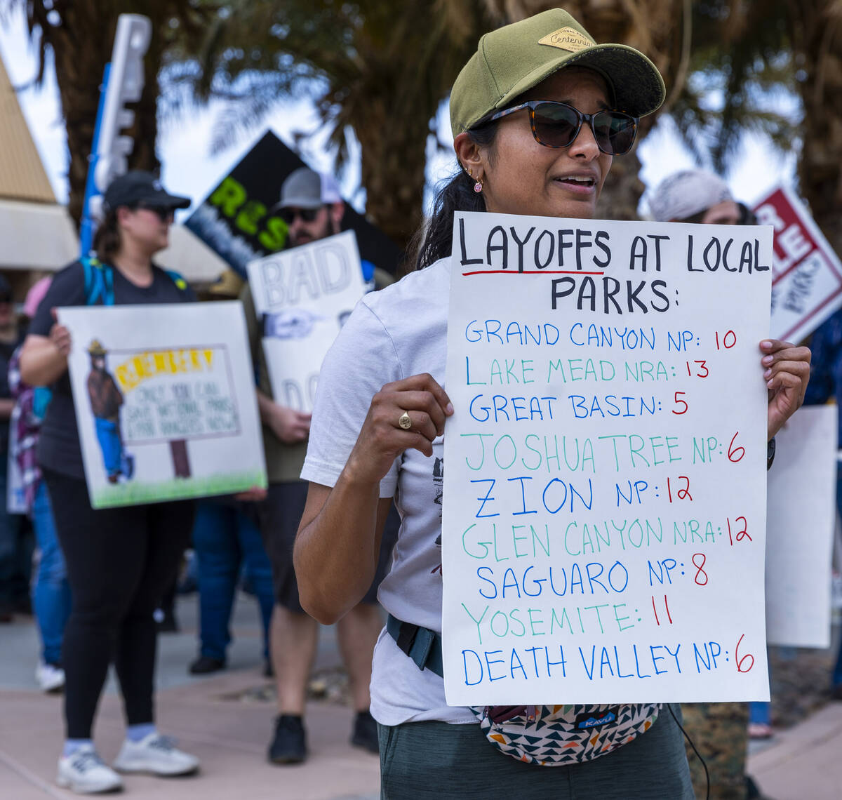 A sign displays possible numbers of layoffs during the Protect Our Public Lands rally to show s ...