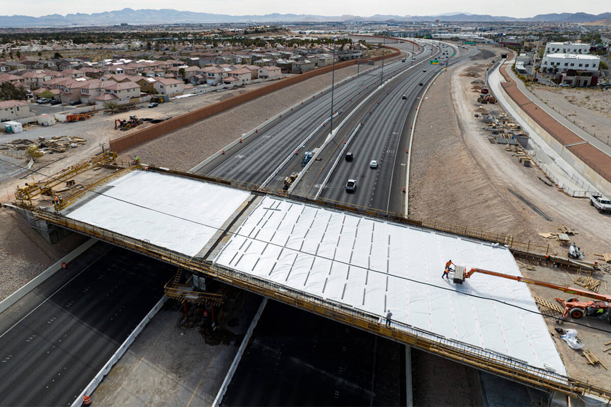 Crews pour concrete on the new Peace Way Bridge over the 215 Beltway, on Saturday, March 1, 202 ...
