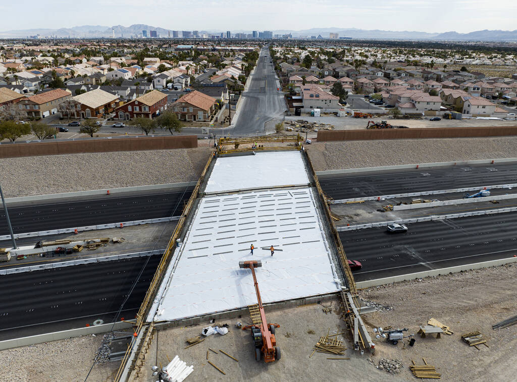 Crews pour concrete on the new Peace Way Bridge over the 215 Beltway, on Saturday, March 1, 202 ...