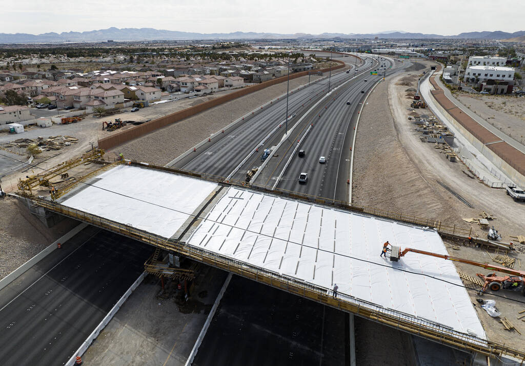 Crews pour concrete on the new Peace Way Bridge over the 215 Beltway, on Saturday, March 1, 202 ...