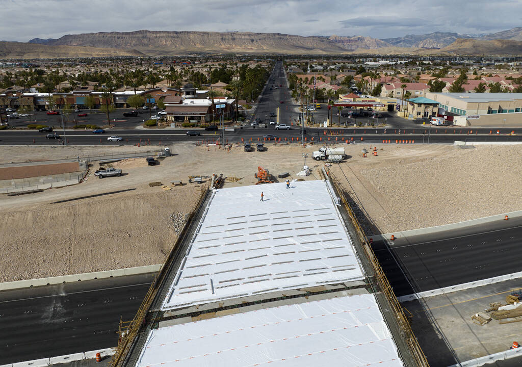 Crews pour concrete on the new Peace Way Bridge over the 215 Beltway, on Saturday, March 1, 202 ...