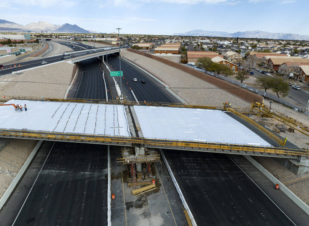 Crews pour concrete on the new Peace Way Bridge over the 215 Beltway, on Saturday, March 1, 202 ...