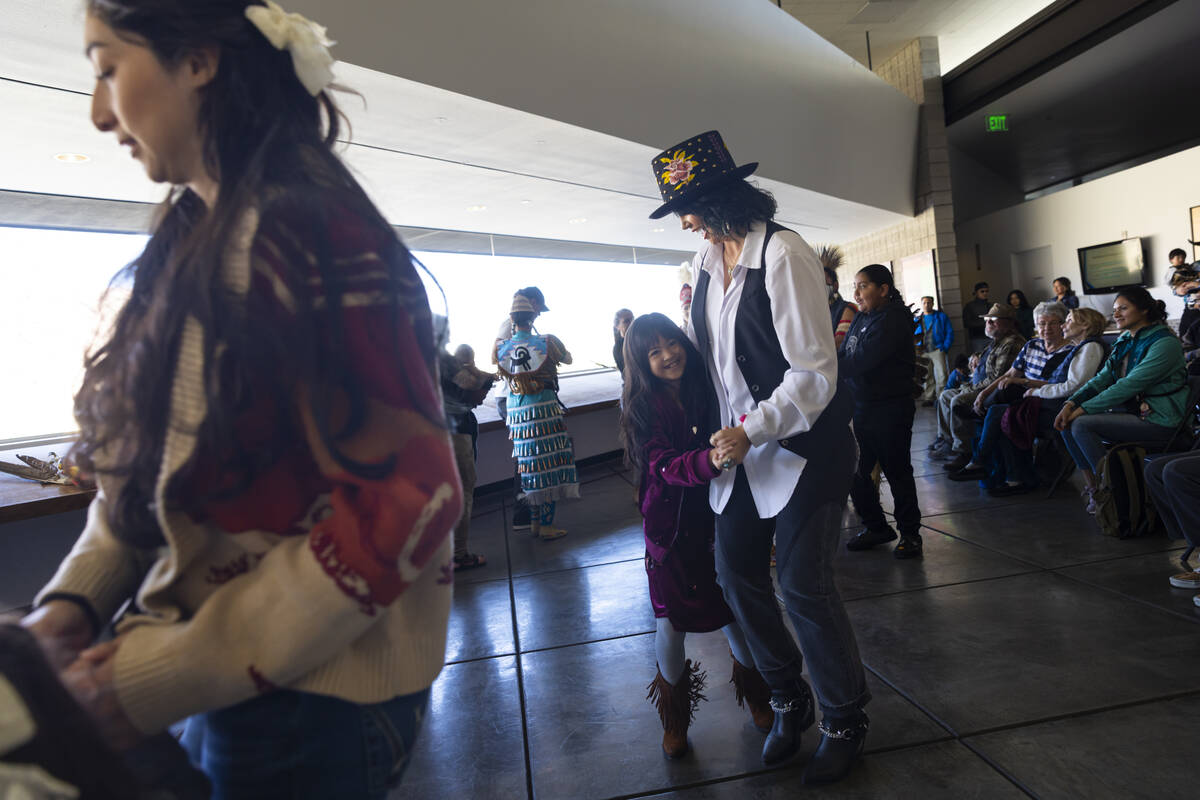 Barbara Hartzell, right, and Bunny Hartzell, 9, of Las Vegas, join in a group dance during the ...