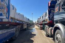 Trucks line up at the Egyptian side of the Rafah border crossing between Egypt and the Gaza Str ...