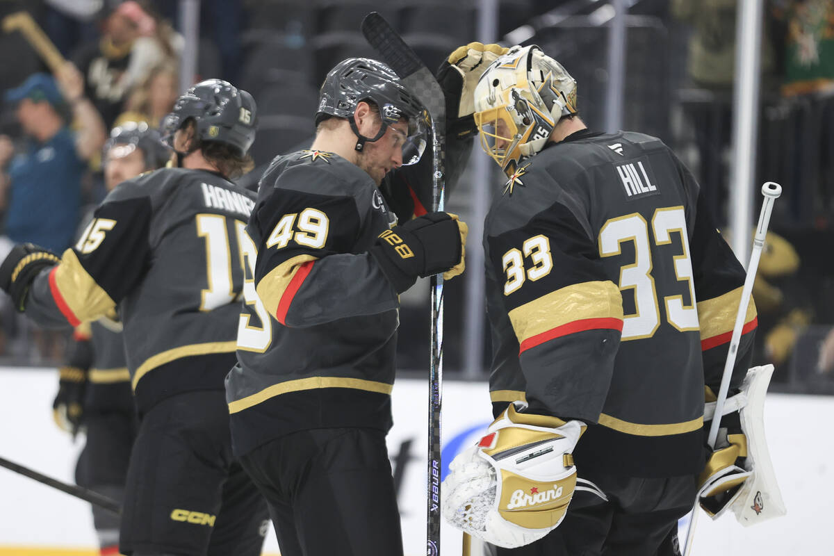 Vegas Golden Knights center Ivan Barbashev (49) and goaltender Adin Hill (33) celebrate during ...