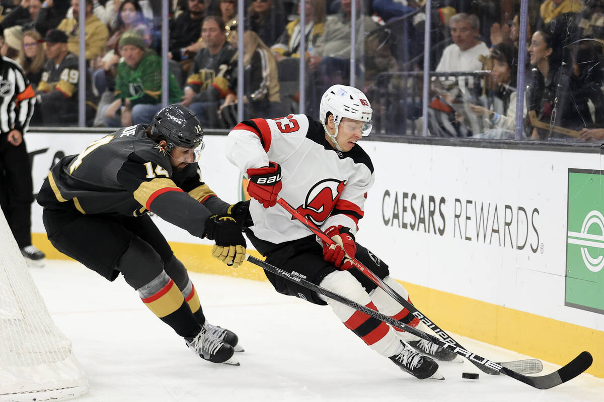 Vegas Golden Knights defenseman Nicolas Hague (14) pressures New Jersey Devils left wing Jesper ...