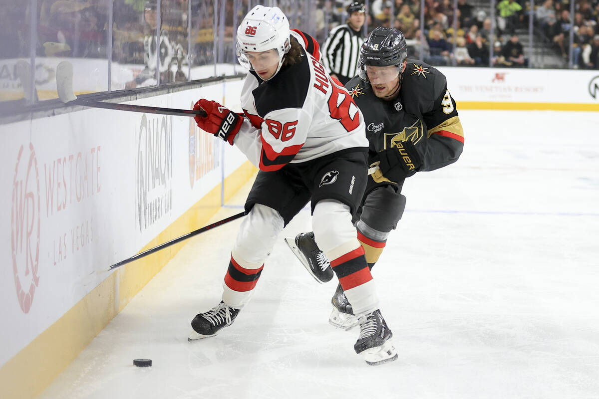 New Jersey Devils center Jack Hughes (86) and Vegas Golden Knights center Jack Eichel (9) battl ...