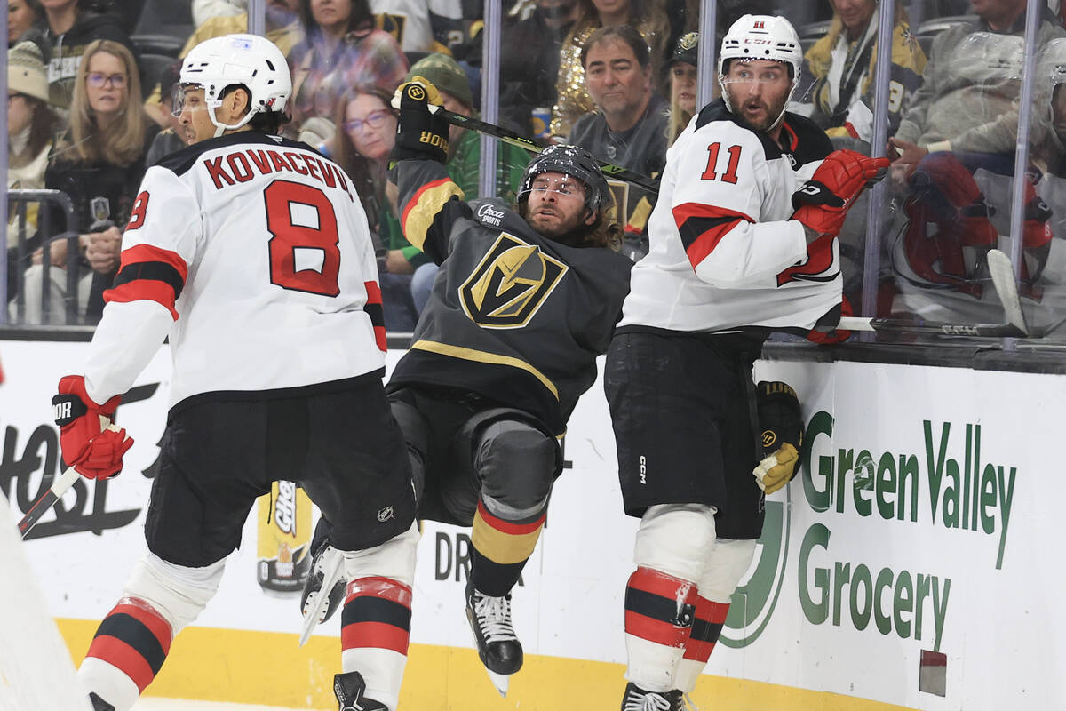 New Jersey Devils defenseman Johnathan Kovacevic (8) checks Vegas Golden Knights left wing Bran ...