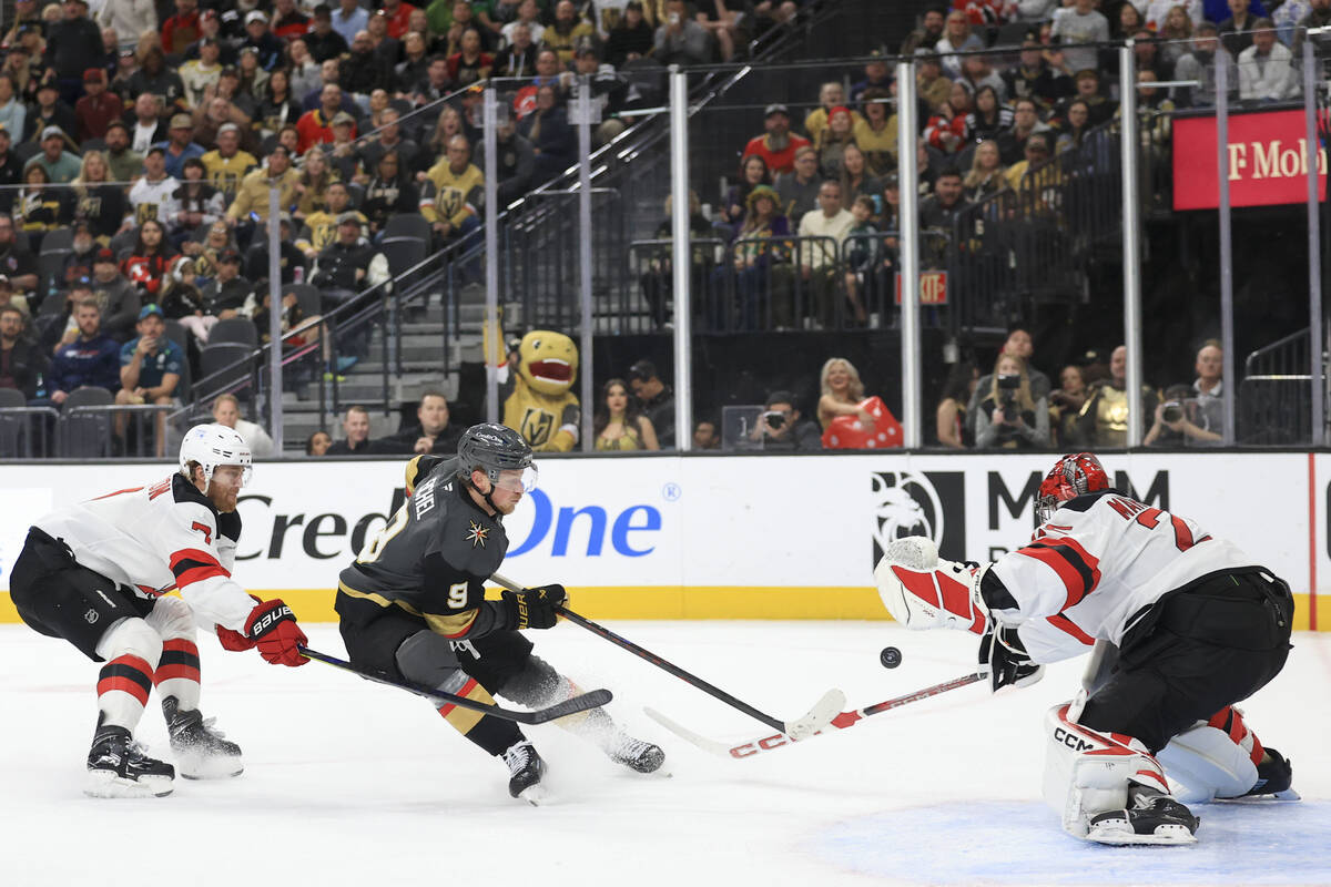 New Jersey Devils defenseman Dougie Hamilton and goaltender Jacob Markstrom defend a shot from ...