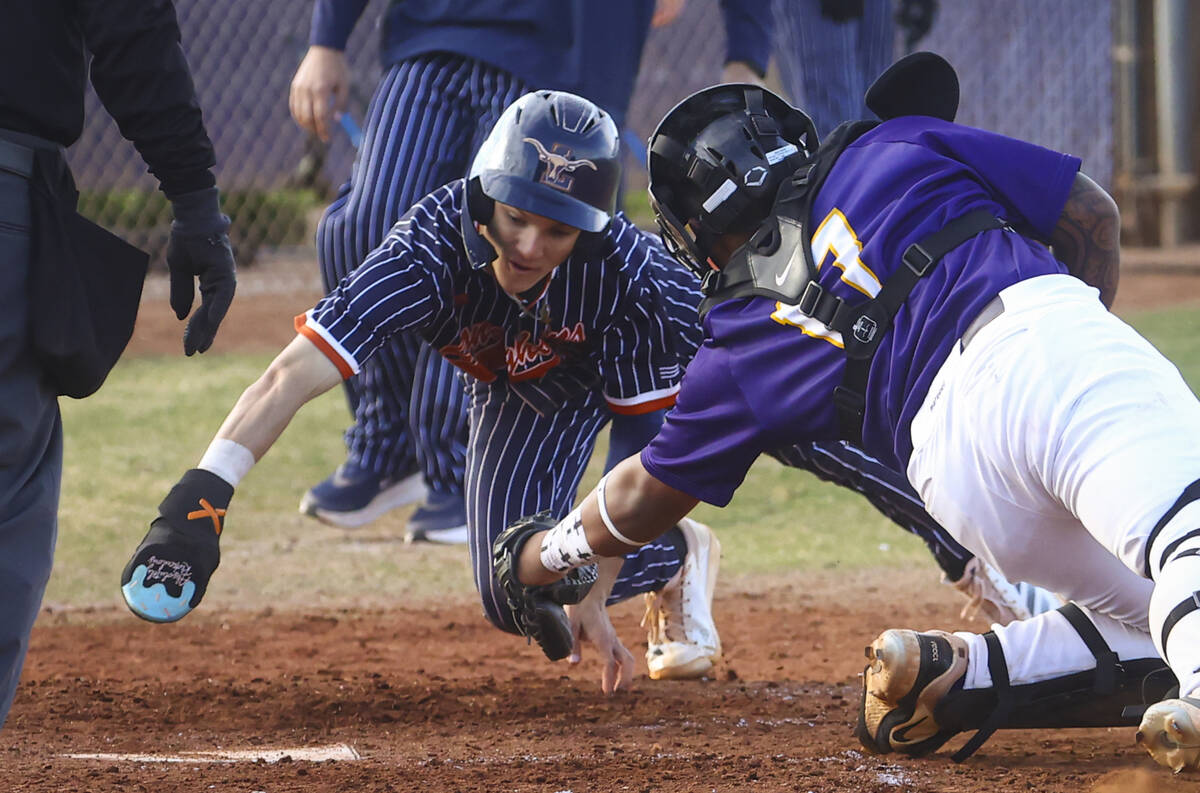 Legacy's Tyson Lake (10) dives around the glove of Durango's Jayden Shuford (17) before reachin ...