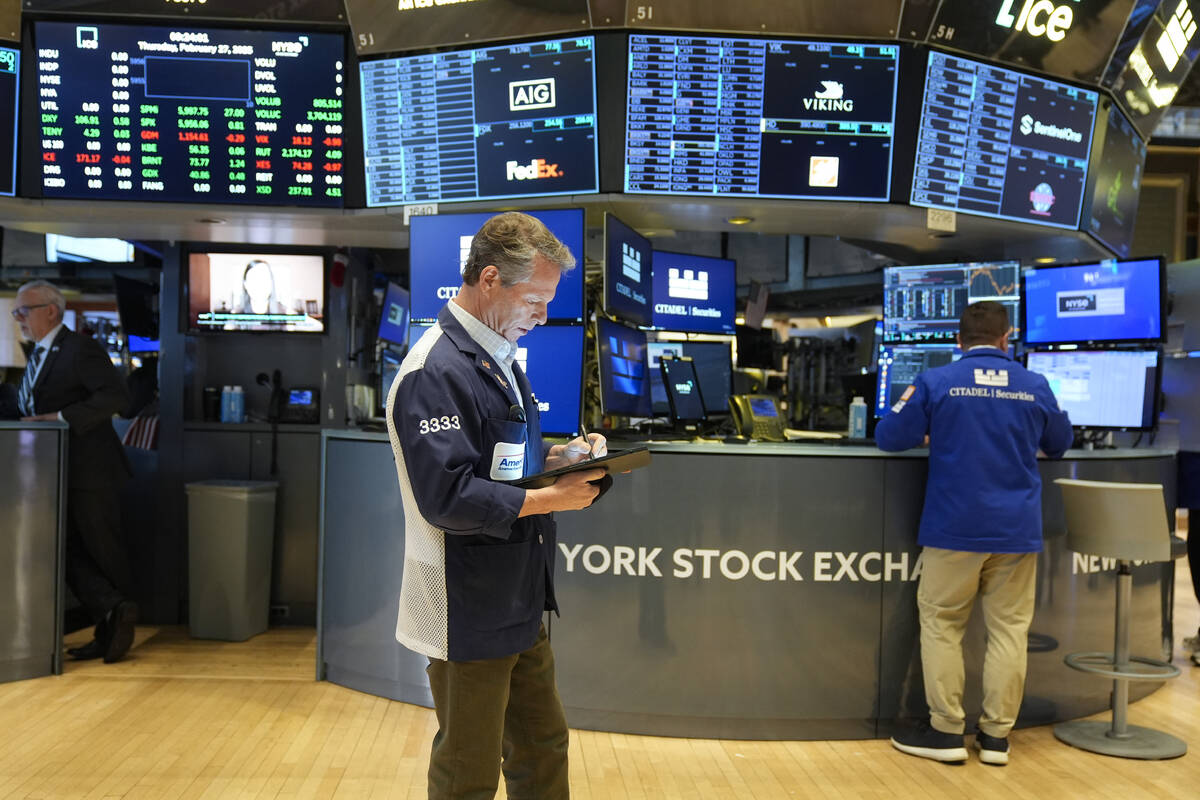 People work on the floor at the New York Stock Exchange in New York, Thursday, Feb. 27, 2025. ( ...