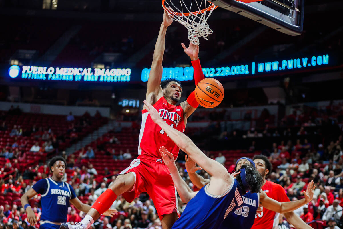 Rebels guard Jailen Bedford (14) attempts a dunk during an NCAA men’s basketball game be ...