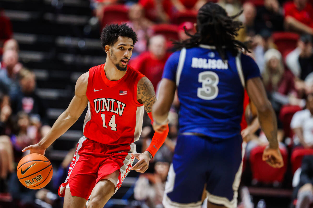 Rebels guard Jailen Bedford (14) dribbles the ball during an NCAA men’s basketball game ...