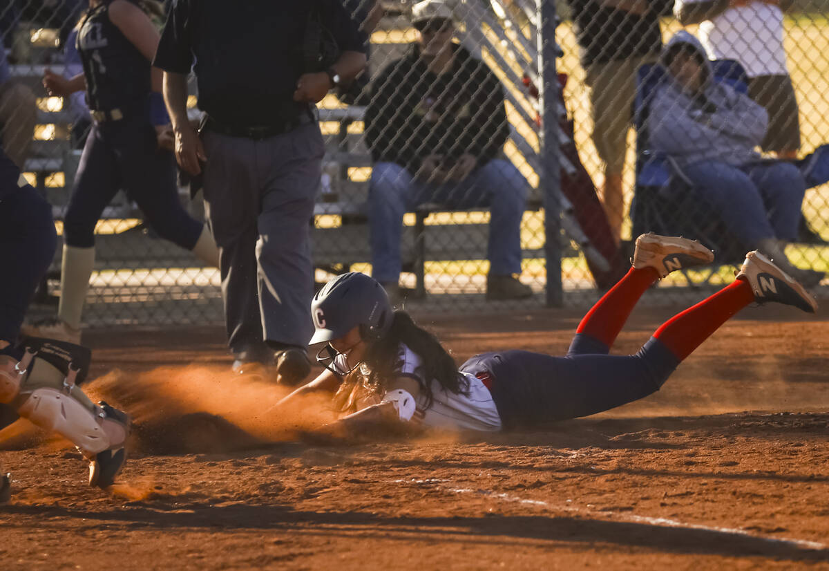 Coronado's Sarah Lopez (5) slides into home plate to score against Foothill during a softball g ...