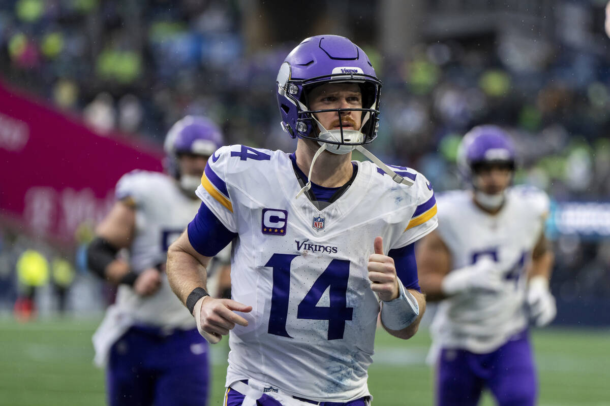 Minnesota Vikings quarterback Sam Darnold jogs off the field during an NFL football game agains ...