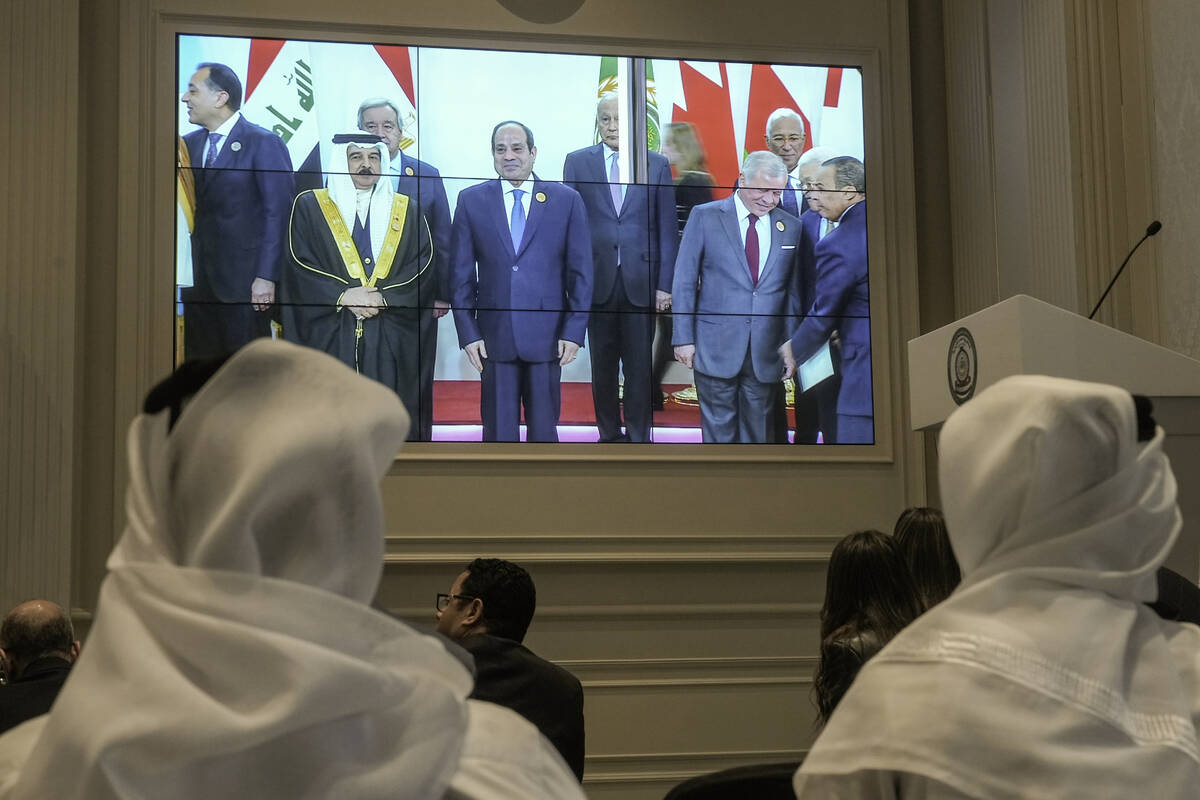 Journalists watch a screen displaying Egyptian President Abdel Fattah el-Sissi, center, with Ar ...