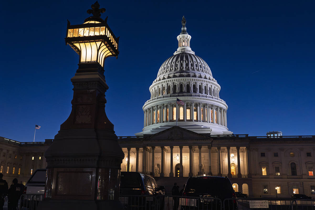 The U.S. Capitol is illuminated at dusk before President Donald Trump's address to a joint sess ...