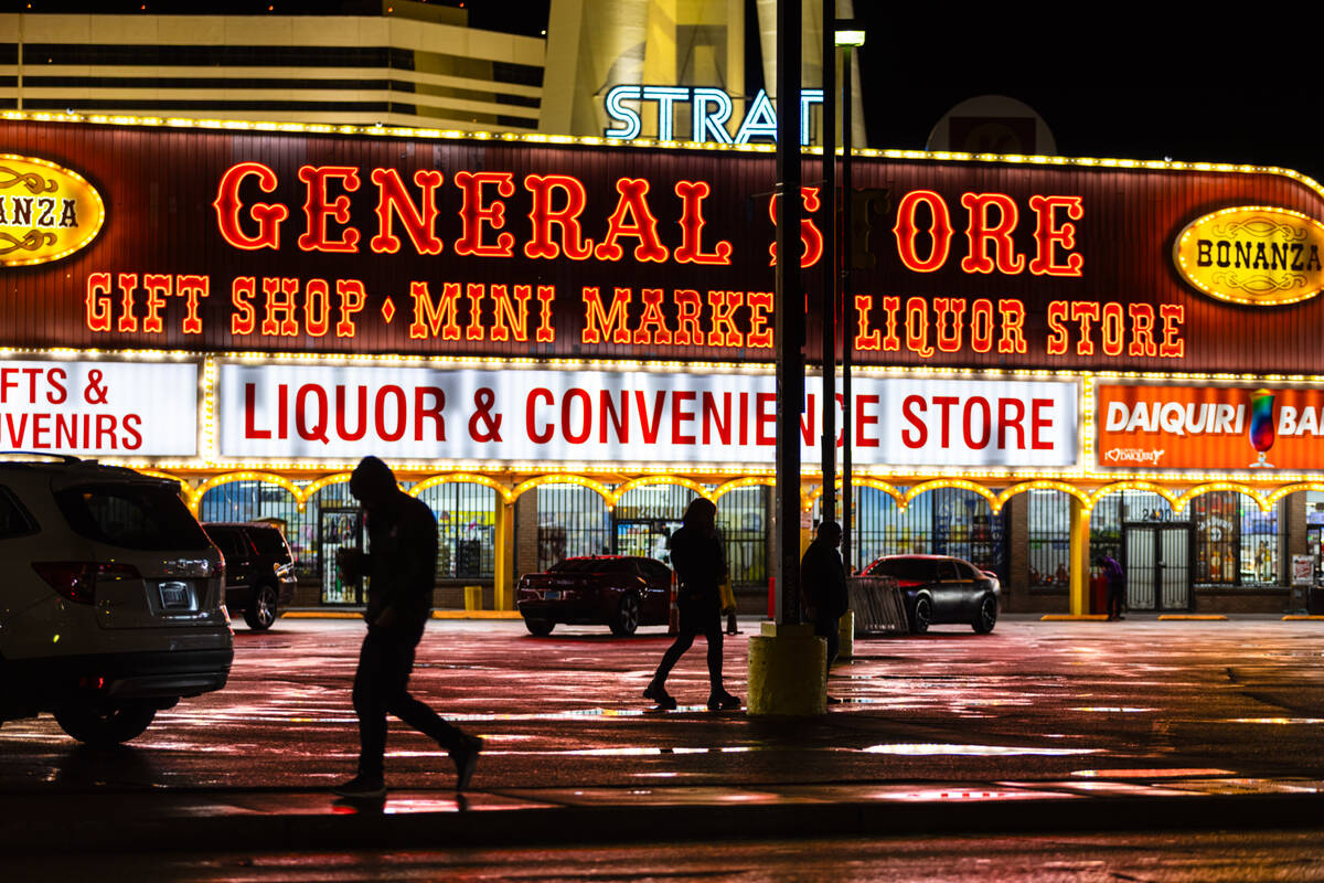 People walk by puddles of water following rain outside of the Bonanza Gift Shop at Las Vegas Bo ...