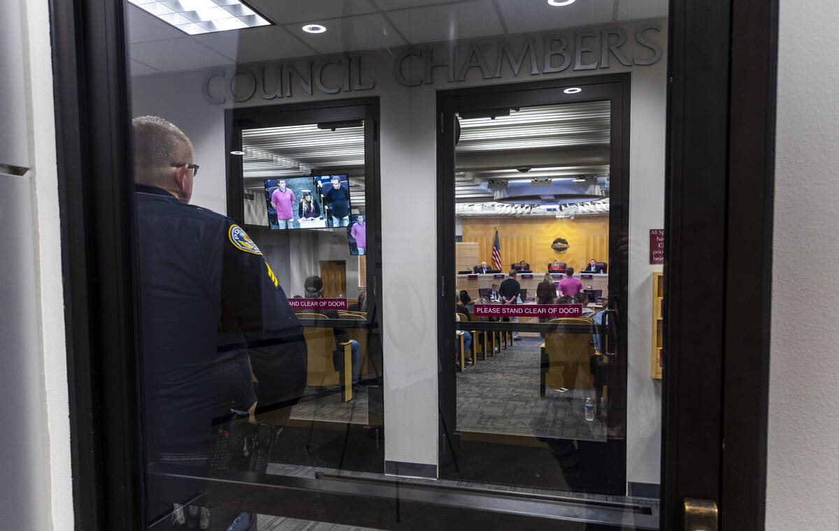 An officer stands by as Mayor Michelle Romero leads a Henderson City Council meeting where many ...