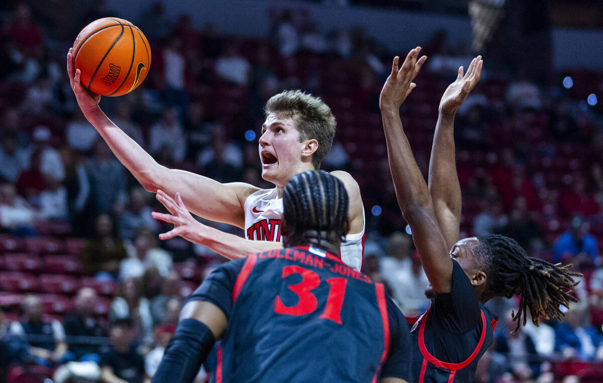 UNLV guard Julian Rishwain (20) gets inside of San Diego State Aztecs guard BJ Davis (10) and f ...