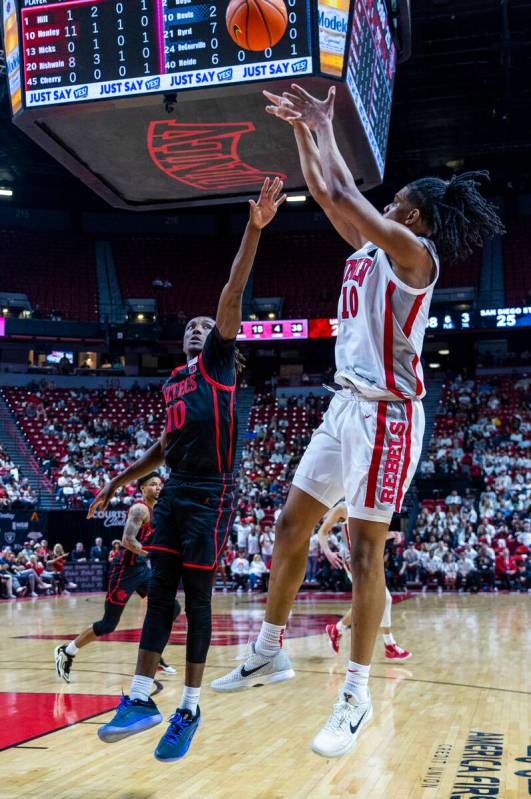 UNLV guard Jaden Henley (10) fades back for a shot over San Diego State Aztecs guard BJ Davis ( ...