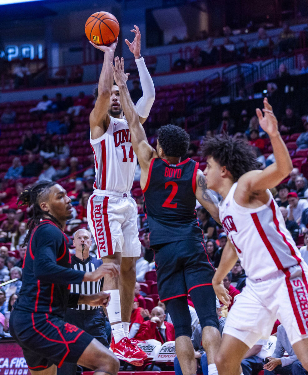 UNLV guard Jailen Bedford (14) elevates for a shot over San Diego State Aztecs guard Nick Boyd ...