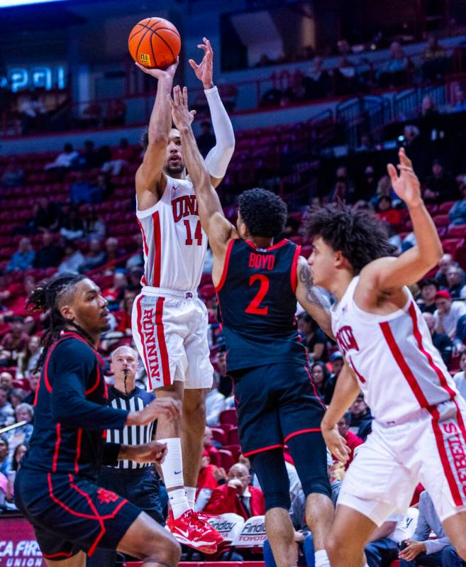 UNLV guard Jailen Bedford (14) elevates for a shot over San Diego State Aztecs guard Nick Boyd ...