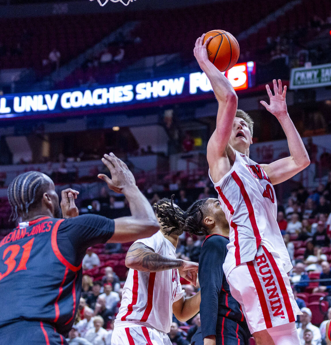 UNLV guard Julian Rishwain (20) works his way inside for a shot as San Diego State Aztecs forwa ...
