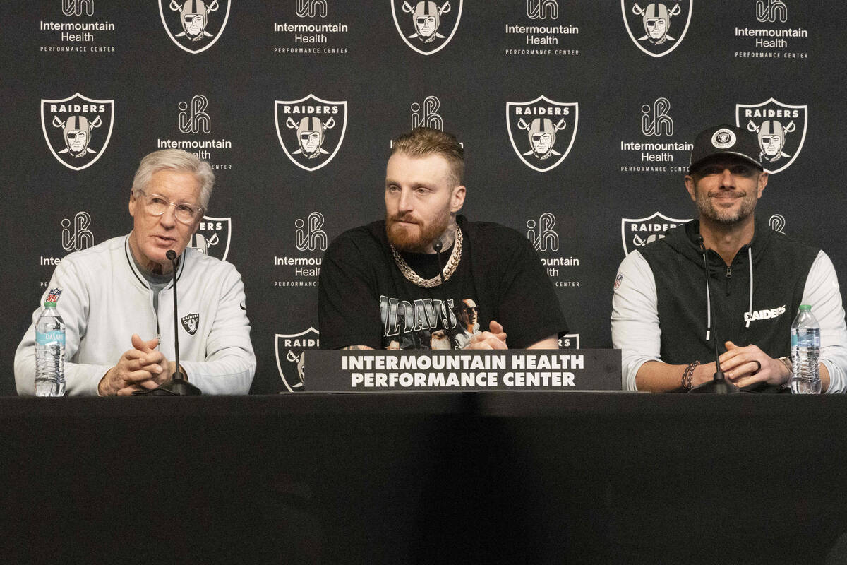 Raiders head coach Pete Carroll, left, speaks during a news conference to announce defensive en ...