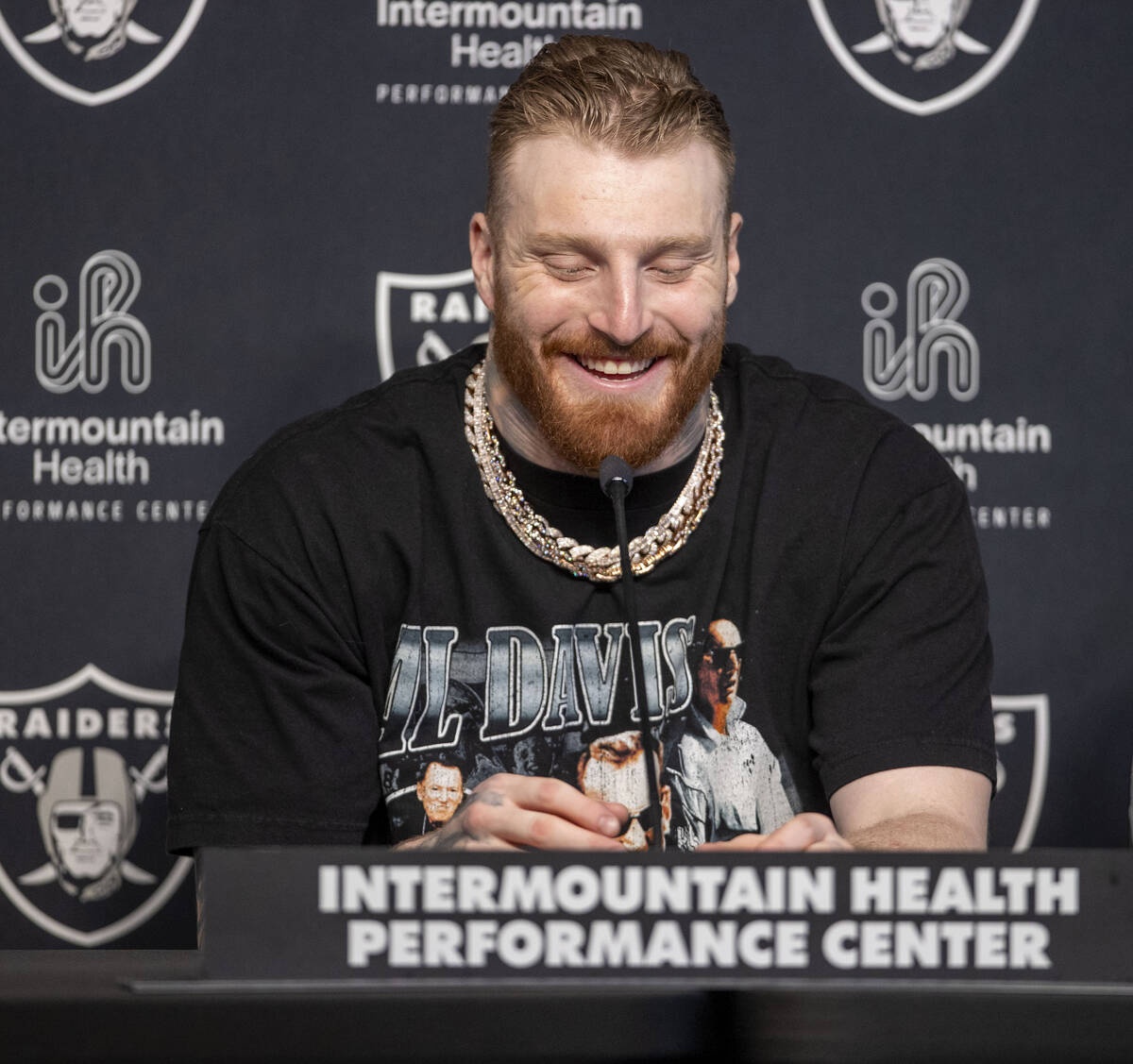 Raiders defensive end Maxx Crosby laughs during a news conference after receiving a contract ex ...