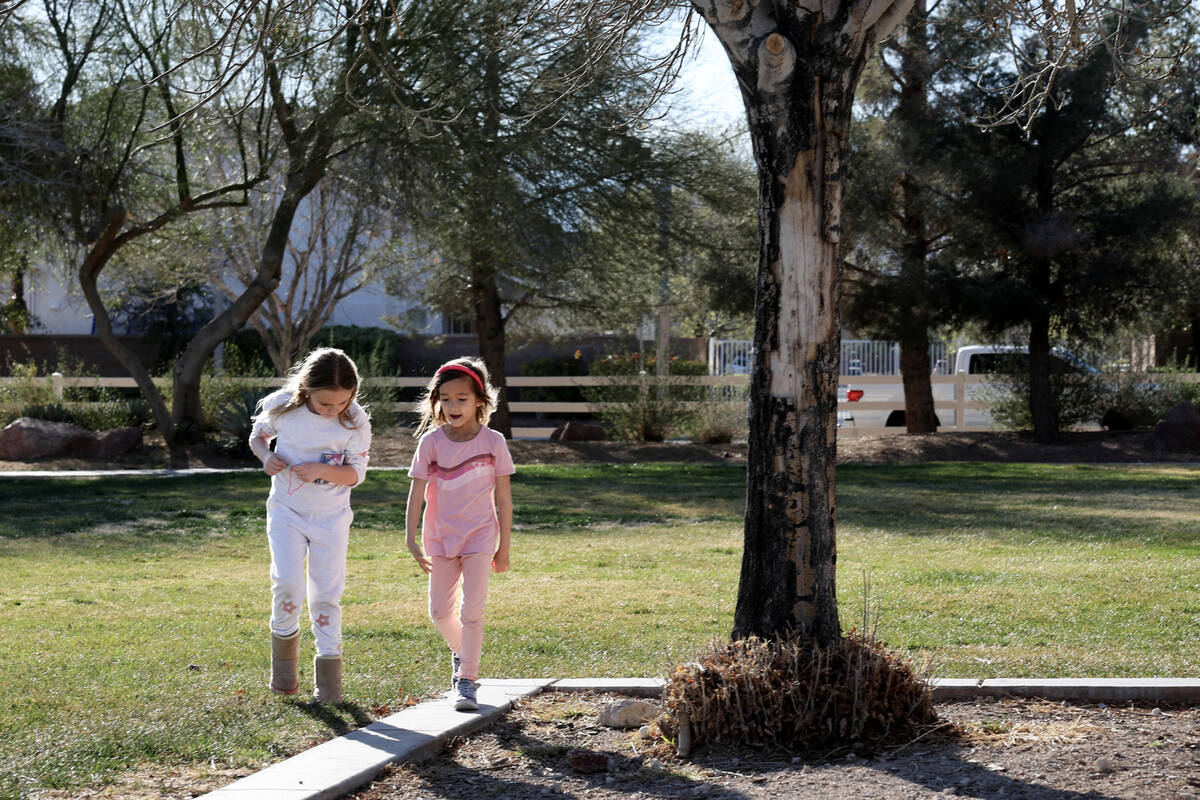 Yoyo Wang, 6, right, whose father was killed by a suspected impaired driver, plays with friend ...
