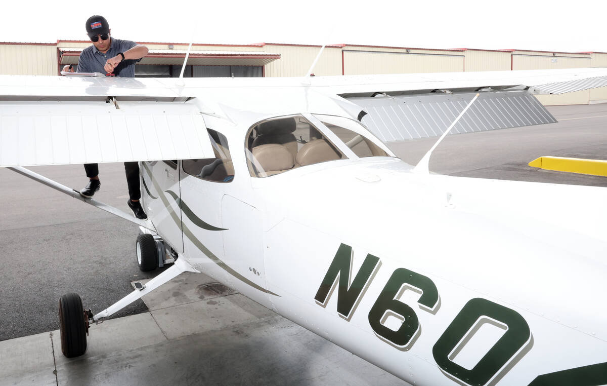 Student pilot Enrique Gomez does a pre-flight inspections on a Cessna 172 Skyhawk at All In Avi ...