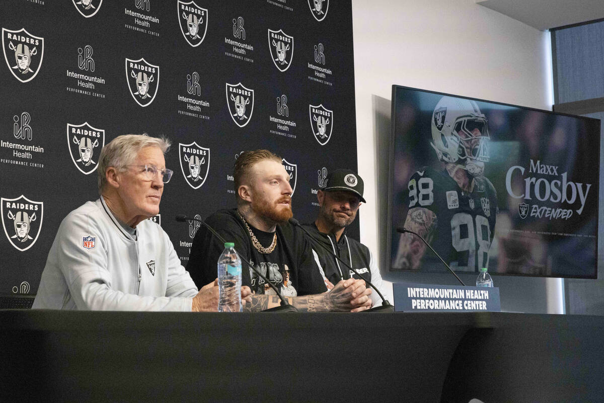 Raiders head coach Pete Carroll, from left, defensive end Maxx Crosby and general manager John ...