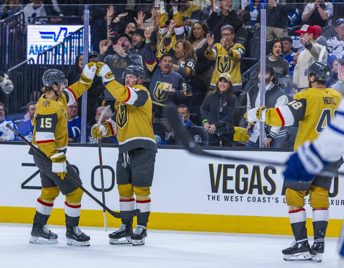 Golden Knights defenseman Noah Hanifin (15) and center Jack Eichel (9) celebrate a goal against ...