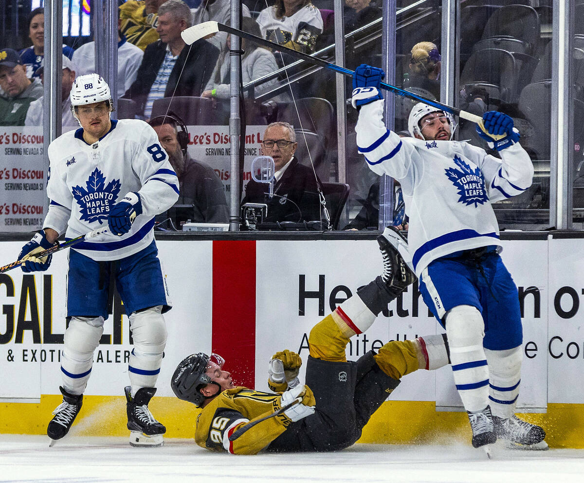 Golden Knights right wing Victor Olofsson (95) is taken out by a double hit from Toronto Maple ...