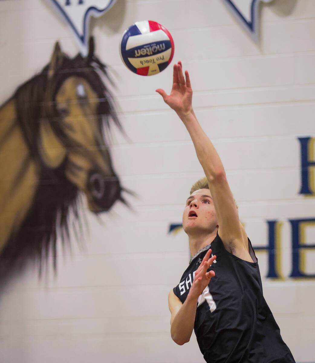 Shadow Ridge opposite hitter Tanner Dixon (4) sets the ball during a high school boys volleybal ...