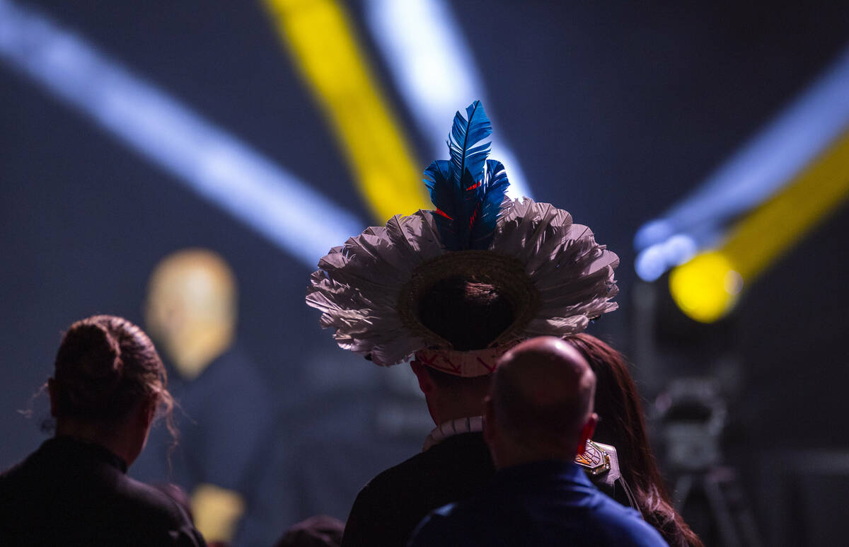 A fan wears a Brazilian feather headdress in honor of fighter Alex Pereira during the UFC 313 p ...