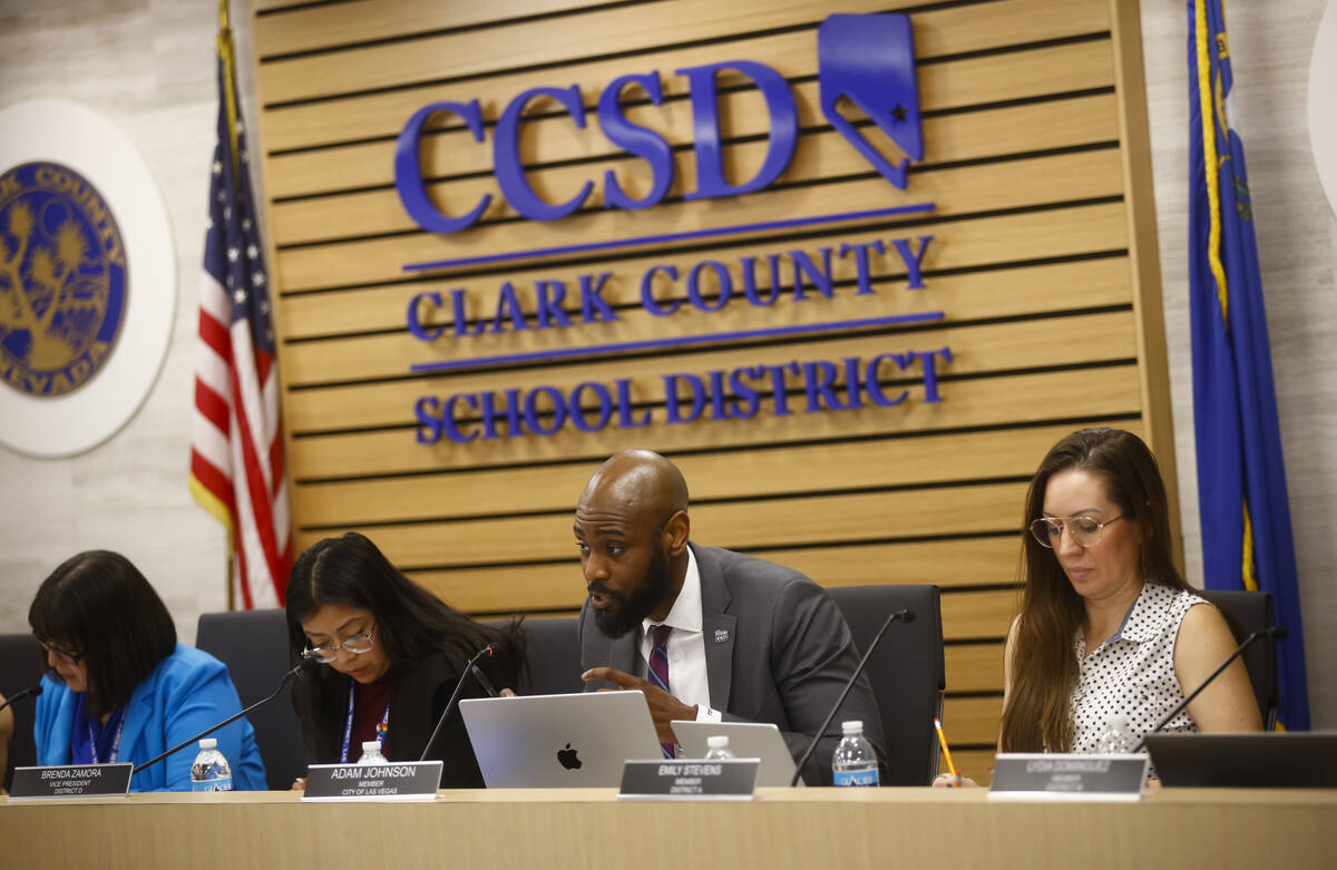 Trustee Adam Johnson asks a question of Ben Shuldiner, superintendent of Lansing School Distric ...