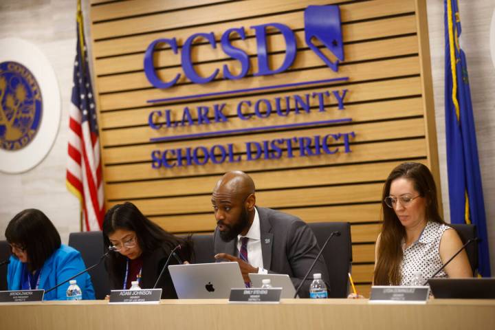 Trustee Adam Johnson asks a question of Ben Shuldiner, superintendent of Lansing School Distric ...